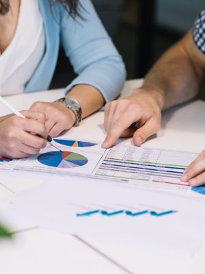 crop-people-comparing-data-chart